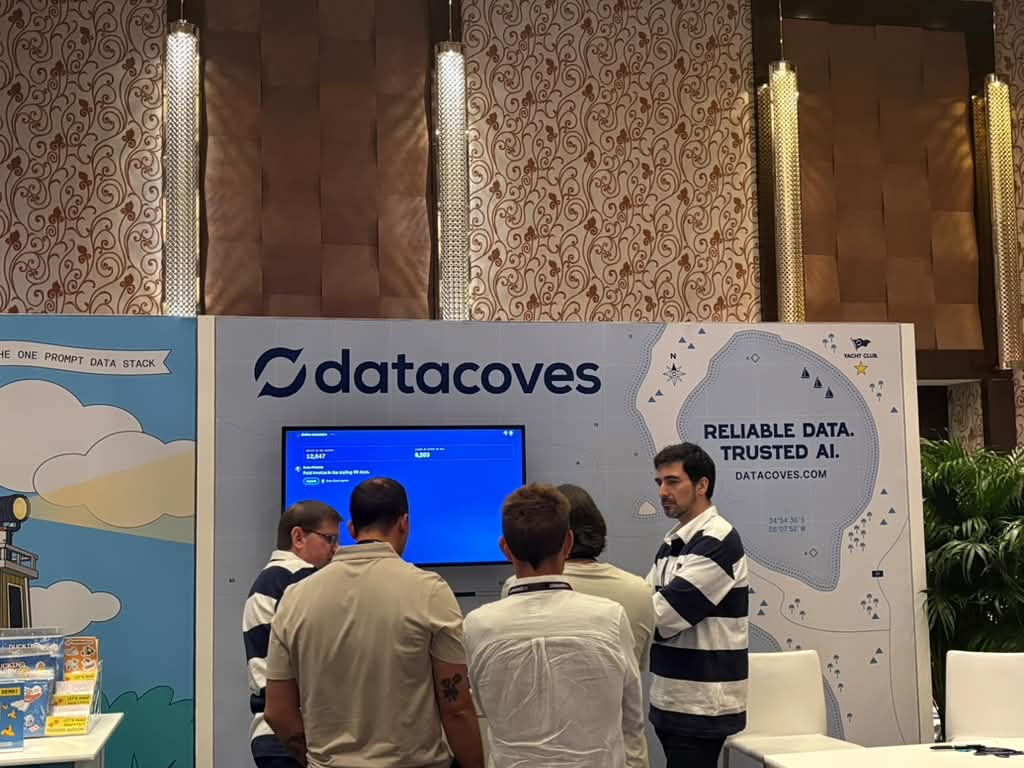 Attendees at the Datacoves booth at dbt Summit 2026, under the Reliable Data. Trusted AI. banner
